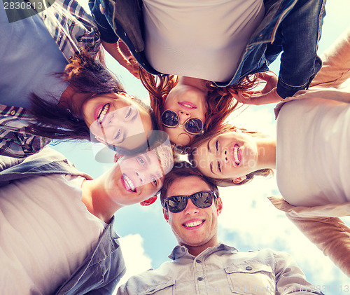 Image of group of teenagers looking down