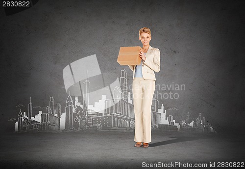 Image of businesswoman delivering cardboard box