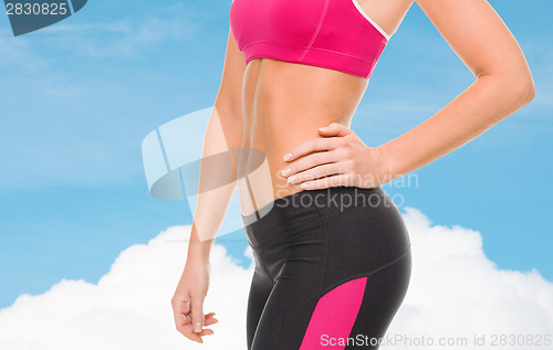 Image of close up of female abs in sportswear