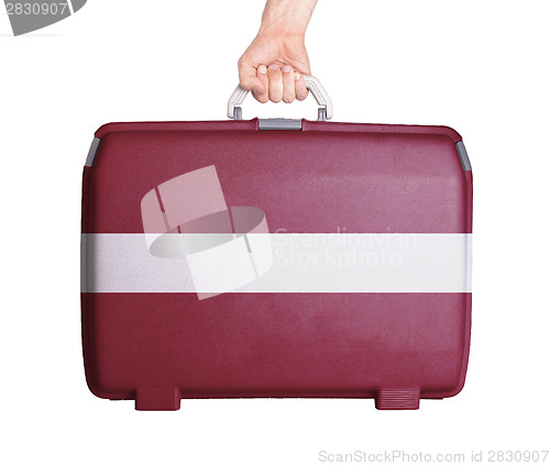 Image of Used plastic suitcase with stains and scratches