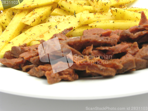 Image of Soy Geschnetzeltes and french fries on white plate