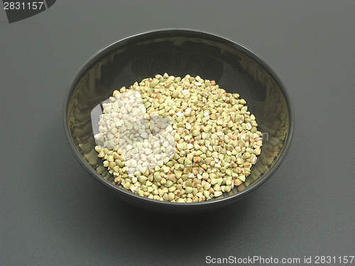 Image of Bowl of chinaware with buckwheat on a dull matting