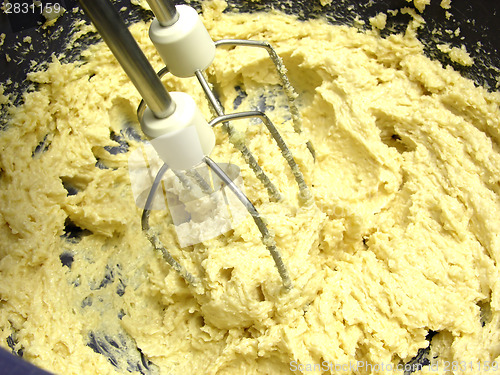 Image of Margarine and cane sugar mixed with stirring staffs in a blue bo