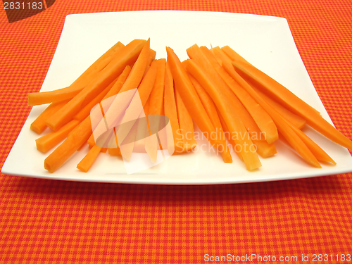 Image of Julienne carrots on a white plate and checked placemat