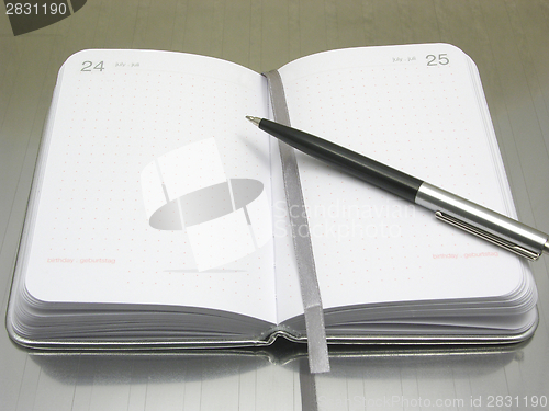 Image of To flip an appointment calendar open with ball pen