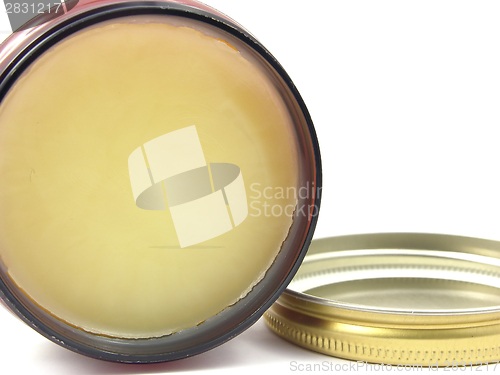 Image of Yellow hair wax in a little open glass with lid