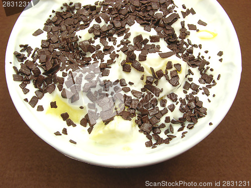 Image of Pieces of pineapple in yogurt and and a white bowl of chinaware