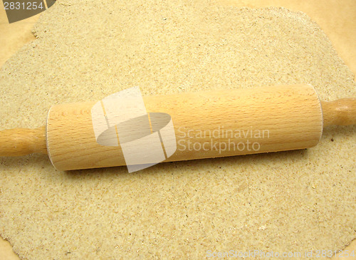 Image of Rolled out  wholemeal dough with a rolling pin