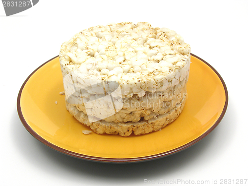 Image of Slices of puffed rice arranged on a bowl of ceramik on white