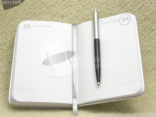 Image of To flip an appointment calendar open with ball pen