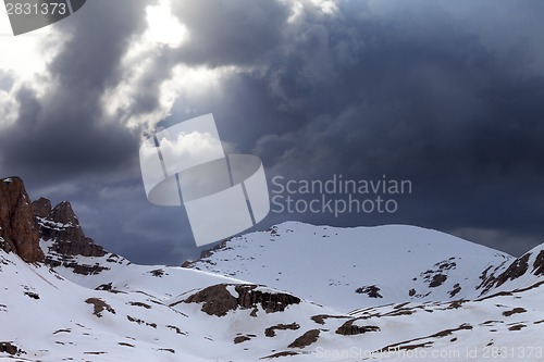 Image of Snowy mountains and storm clouds