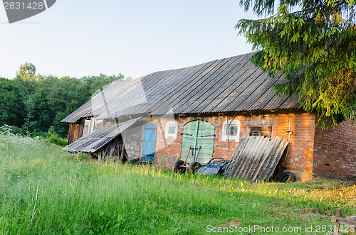 Image of old outbuilding with colored doors rural meadow 