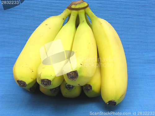 Image of Bananas lying in front of a blue background