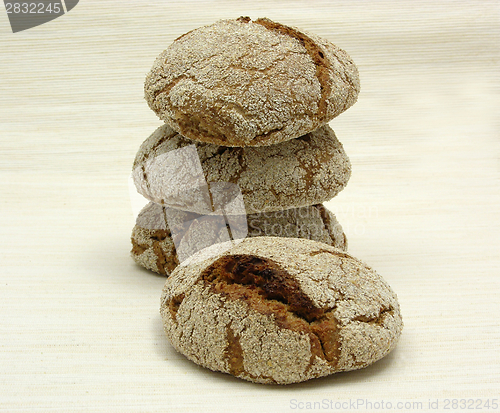 Image of Home made wholemeal vinschgauer buns on beige underlay