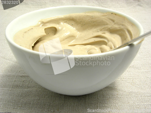 Image of Quark cheese mixed as dip in a bowl of chinaware on a placemat