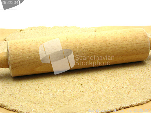 Image of Rolled out  wholemeal dough with a rolling pin