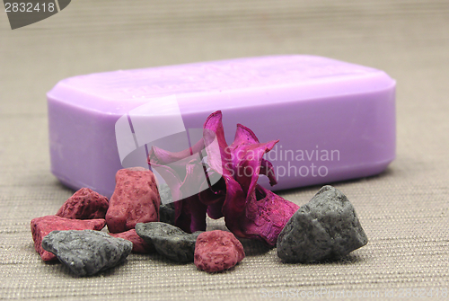 Image of Lilac soap with decoration articles on a  gray  background