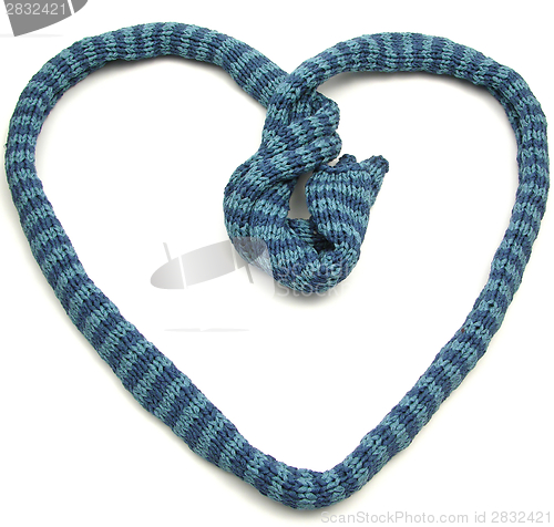 Image of Blue striped knitting scarf arranged as heart on white