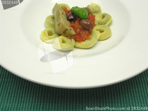 Image of Tortellini  with tomato sauce, olives, basil  and artichoke