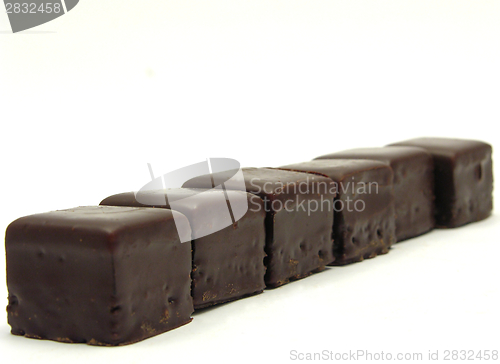 Image of A few dominos arranged in line on white background