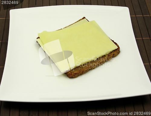 Image of Wholemeal bread with two slices of cheese on a plate 