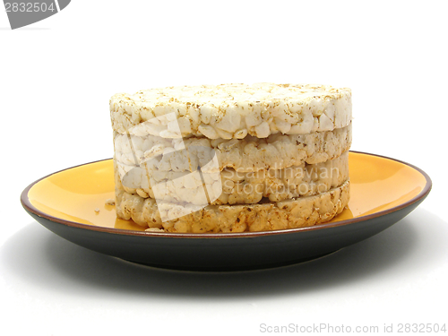 Image of Slices of puffed rice arranged on a bowl of ceramik on white