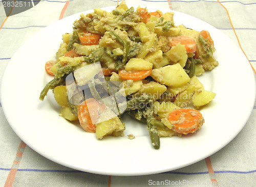 Image of Vegetarian vegetable casserole on a white plate and checked tabl