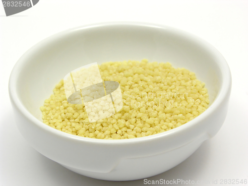 Image of Yellow couscous in a white bowl of chinaware