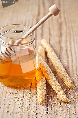 Image of grissini with sesame seeds and honey