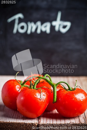 Image of fresh tomatoes and blackboard