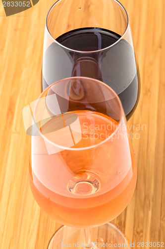 Image of Glasses of Red and Pink Wine on Wooden Table