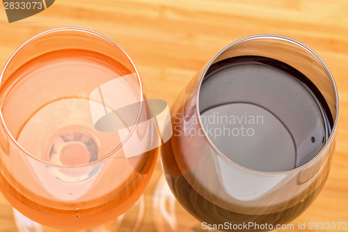 Image of Glasses of Red and Pink Wine on Wooden Table