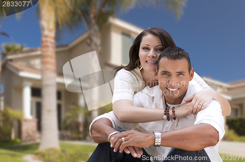 Image of Happy Hispanic Young Couple in Front of Their New Home