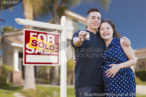 Image of Hispanic Couple, Keys, New Home and Sold Real Estate Sign