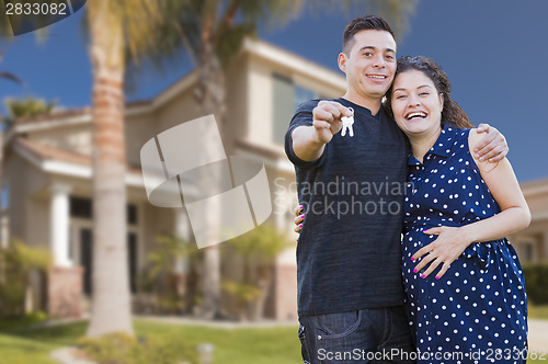 Image of Hispanic Couple with House Keys In Front of New Home