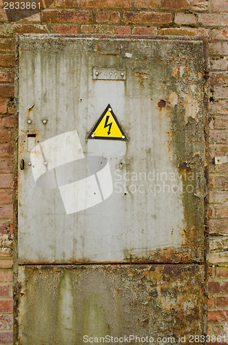 Image of door with yellow warning sign of danger 