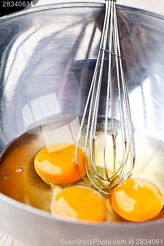 Image of whisking eggs in metal bowl 