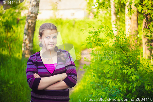 Image of A Beautiful Young Girl Standing On A Forest Path Road