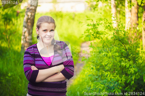 Image of A Beautiful Young Girl Standing On A Forest Path Road