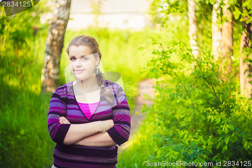 Image of A Beautiful Young Girl Standing On A Forest Path Road