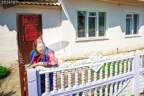 Image of An elderly woman of the Belarusian village waits to receive medi