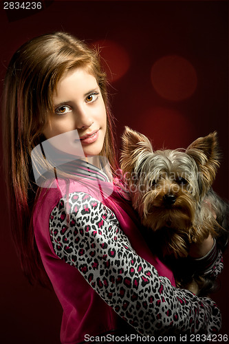 Image of smiling young girl with her pet yorkshire