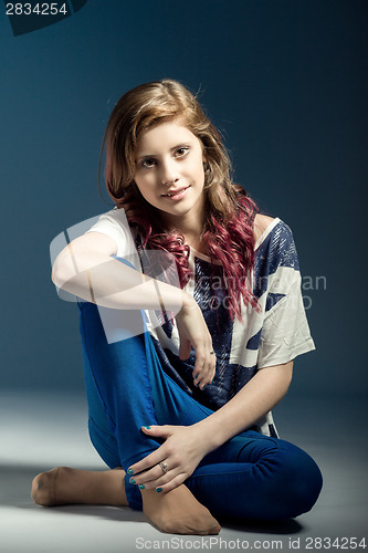 Image of sitting fashion portrait of young beautiful girl