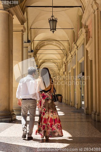 Image of Couple walking streets of Bologna, Italy