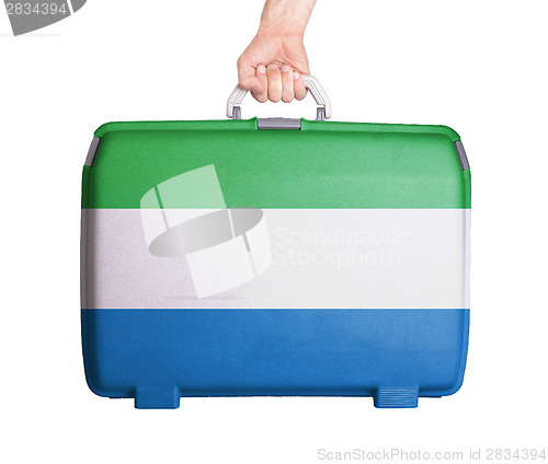 Image of Used plastic suitcase with stains and scratches
