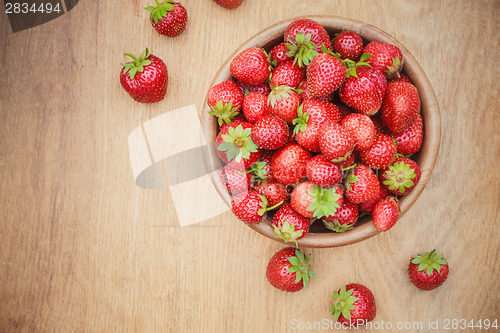 Image of Close-Up Of Strawberries In Vintage Wooden Bowl On Table