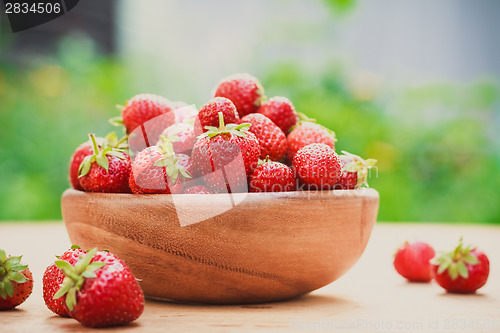 Image of Close-Up Of Strawberries In Vintage Wooden Bowl On Table
