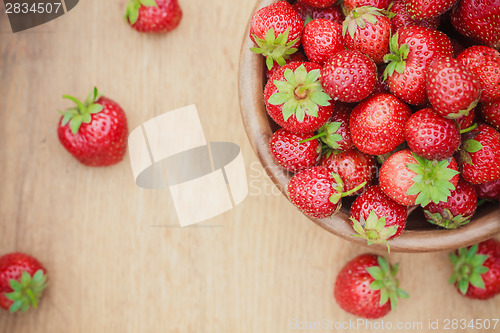 Image of Close-Up Of Strawberries In Vintage Wooden Bowl On Table