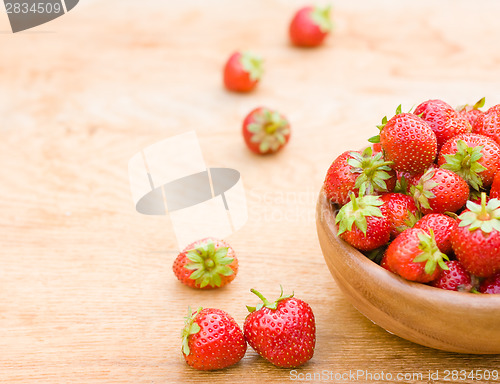 Image of Close-Up Of Strawberries In Vintage Wooden Bowl On Table