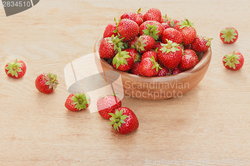 Image of Close-Up Of Strawberries In Vintage Wooden Bowl On Table